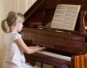 kid playing at piano